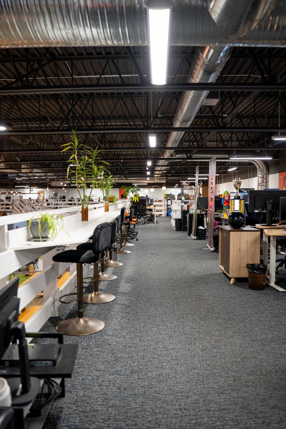 Long rows of desks in a bright, open workspace